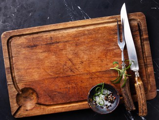 Cutting board with cutlery, rosemary and spices