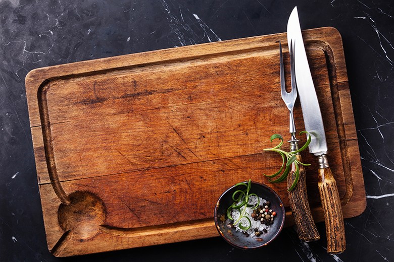 Holiday Hacks | Food & Nutrition | November-December 2017 Cutting board with cutlery, rosemary and spices
