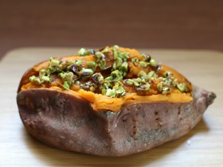 Baked sweet potato topped with honey-pistachio mixture