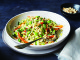 edamame slaw in white bowl with fork