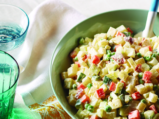 Creamy potato salad in green bowl