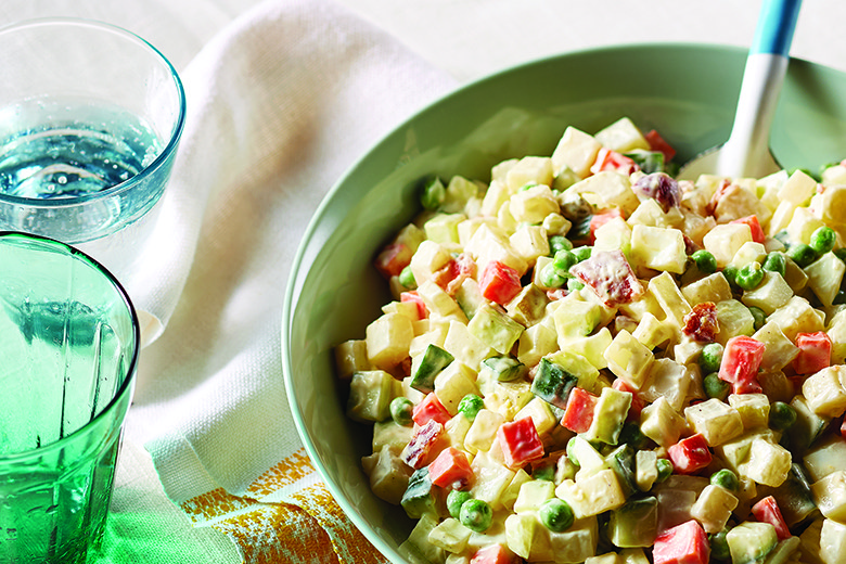 Creamy potato salad in green bowl