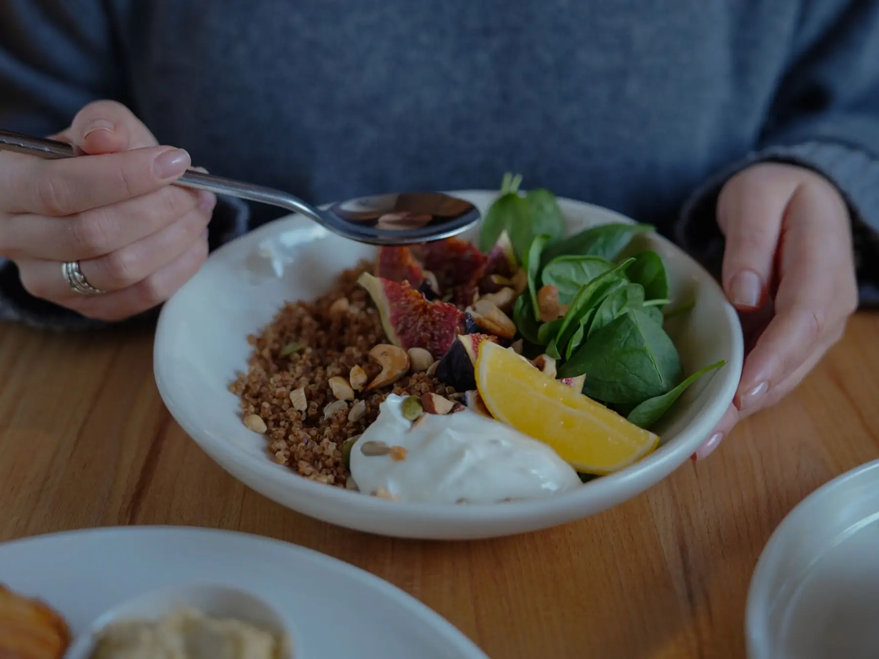A vibrant brunch bowl with fruit, greens, and nuts for a nutritious meal